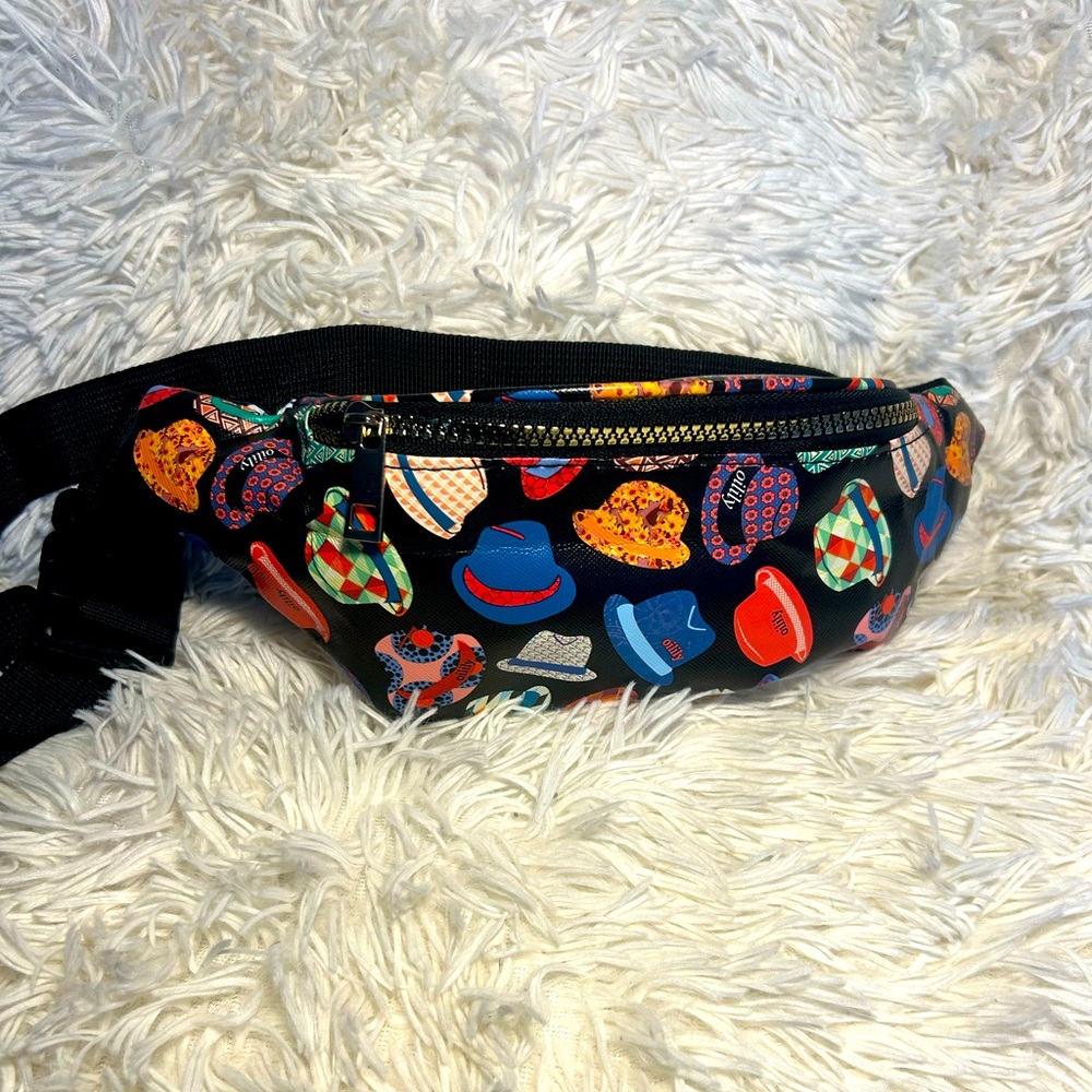 Black Fanny pack with colorful hats and gold zipper in the front.
